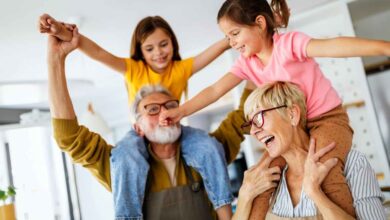 due nonni hanno sulle spalle i nipotini