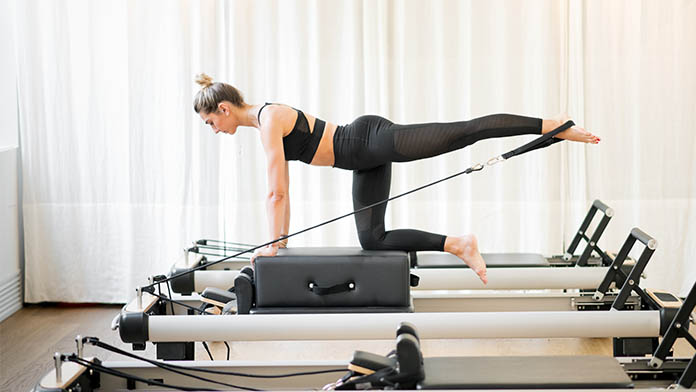 donna che pratica pilates reformer per allenamento