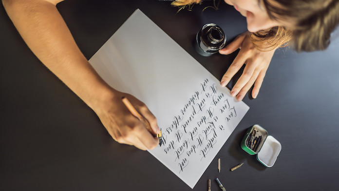 una ragazza scrive a mano una lettera