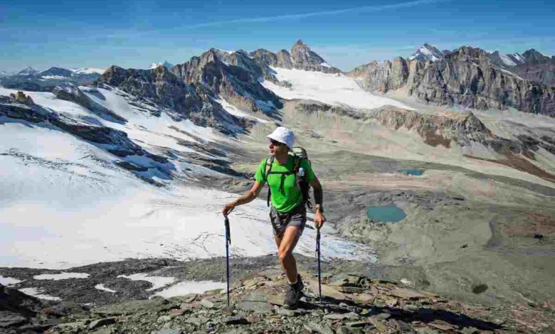 un uomo di cinquanta anni fa nordic walking vicino a un ghiacciaio