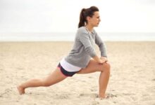 donna che si allena in spiaggia senza attrezzi