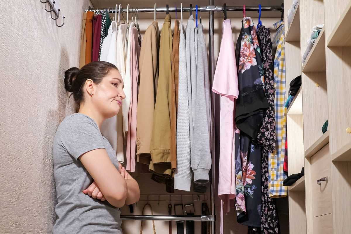 donna che guarda l'armadio al mattino perché non sa cosa mettersi