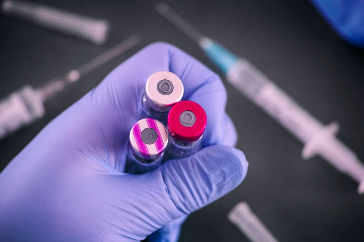 primo piano di un guanto che ha in mano vaccini 