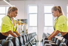 una donna in palestra sceglie i manubri da sollevare