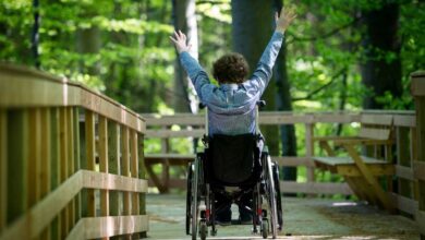 ragazzino di spalle sulla sedia a rotelle con distrofia di duchenne
